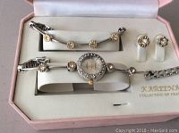 View of watch, bracelet, and earrings displayed in pink box labeled 'Kareena Collection of France'