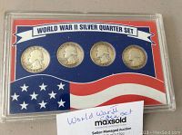 Front view of the World War II Silver Quarter Set in plastic case showing four quarters dated 1942, 43, 44, 45 with American flag design