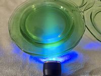 UV light showing green uranium glass plate fluorescing