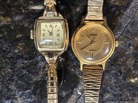 Close view of both watches showing dials and cases