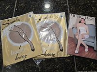 Front view two Princess Grace stocking packs and one Music Legs pantyhose pack