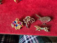 Front view of four rhinestone brooches on red background