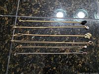 Six necklaces laid flat showing overall length and chain styles