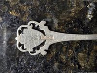 Close-up of hallmarks on back of handle showing R&B, lion passant, anchor, date letter