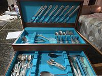 Open cutlery chest showing overall contents in two tiers