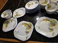 Group of octagonal plates, bowls and cups on countertop