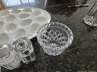 Close view of compote bowl, salt shaker, pepper mill and portion of platter