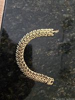 Full view of bracelet curved on dark surface