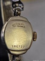 Back of watch showing Liberty 14K Gold stamp and serial 385720