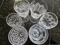 Top view showing six different pressed glass sherry glasses