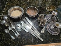 Full layout of assorted silverplate items on countertop