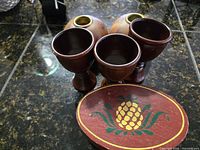 Front view of box lid, three goblets, two bud vases