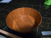 Top view of round teak bowl on countertop