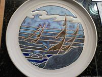Front view of stoneware plate with sailboat scene