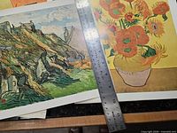 Three Van Gogh prints spread on surface; steel ruler indicates sheet size