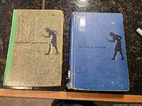 Front covers of both Nancy Drew books showing wear and tape repair