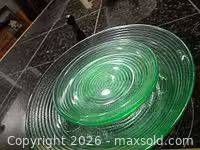 Two stacked green textured plates showing size difference and concentric ribbing