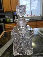 Full view of square cut crystal decanter with stopper in place