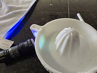 Top view of white milk glass juice reamer showing cone and bowl