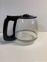 Side view of glass carafe showing handle and 12-cup marking