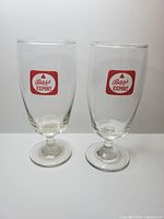 Pair of Bass Export Ale stemmed glasses upright
