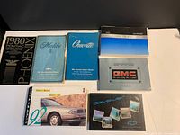Eight vehicle owner manuals laid out