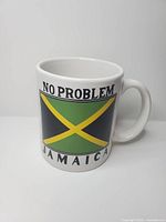 Front view showing Jamaican flag graphic and text on mug