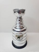 Front view of silver miniature Stanley Cup with Dallas Stars logo