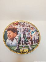 Front view of decorative plate featuring Dan Marino illustration and Quarterback Club logo