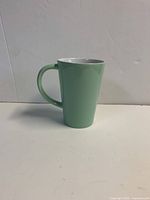 Pastel green ceramic mug front view