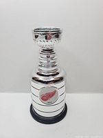 Full view of chrome miniature Stanley Cup showing logo and base