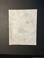 Front view of stack showing faint printed banknote pattern