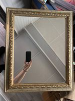 Front view of rectangular mirror with gold ornate frame