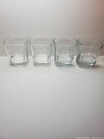 Four clear glass Jack Daniel's Old No.7 embossed rocks glasses on white background