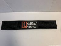 Full view of Ketel One Vodka rubber bar mat showing logo and textured surface
