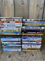 Two vertical stacks of DVD cases showing all spines for title identification