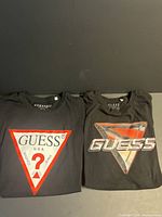 Front view of both Guess t-shirts side by side