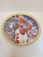 Front of porcelain plate showing Jordan image, gold rim, printed signature