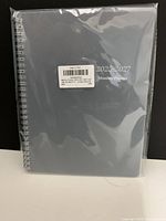 Front view of sealed grey spiral planner