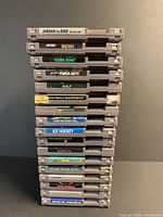 Stack of 17 NES cartridges showing spine titles