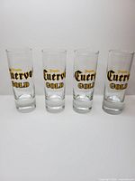 Four Jose Cuervo Gold shot glasses standing