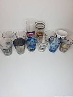 Group view of 11 shot glasses arranged on white background