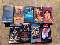 Front view of nine VHS tapes laid out showing cover art and titles