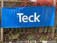 Full view of blue Teck vinyl banner outdoors