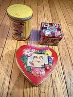 Front view showing all three tins and lids