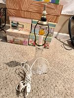 Full view of crystal table lamp with cord coiled on carpet