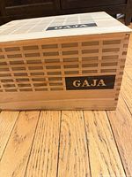 side view of GAJA wooden box showing logo and slotted design