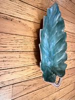 Top view of green leaf-shaped Stangl dish showing glaze and handle