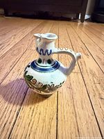 Front view of jug showing painted decoration and form