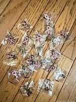 Group view of 22 individually wrapped pink ribbon pins